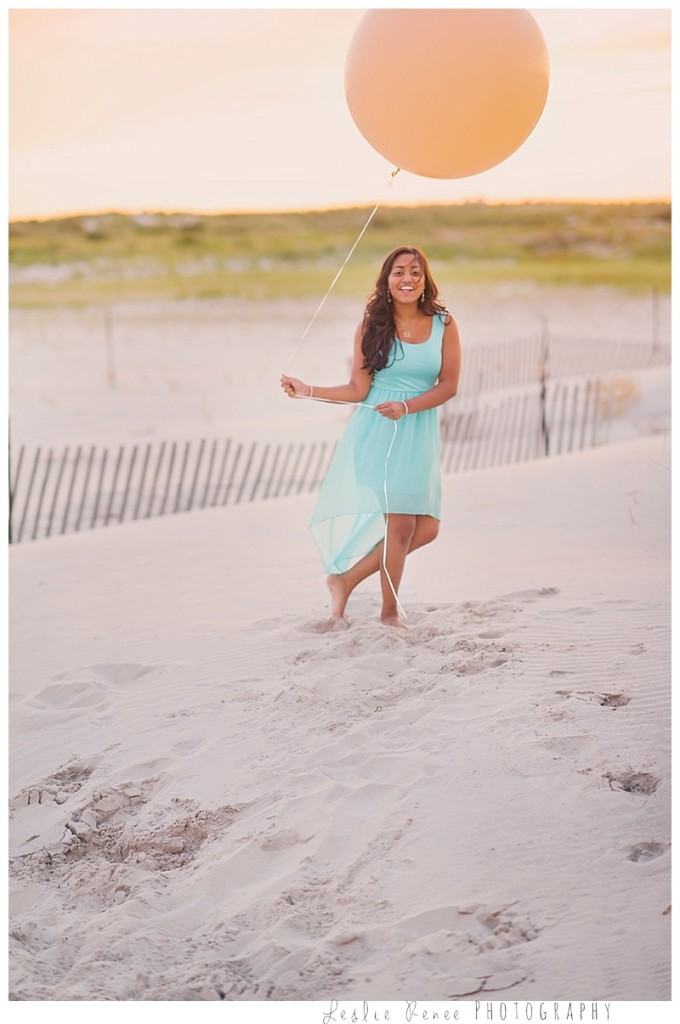 Oceanside sister with balloon on beach