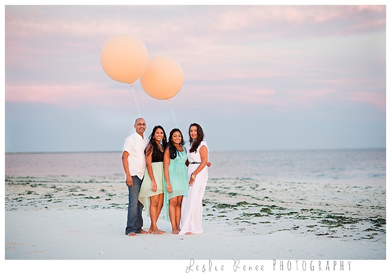 Oceanside family at sunset at Nickerson Beach with giant balloons