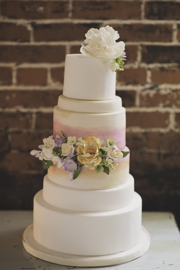 red barn wedding cake with flowers