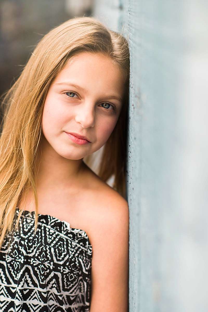East Rockaway Family Photographer young girl by the wall