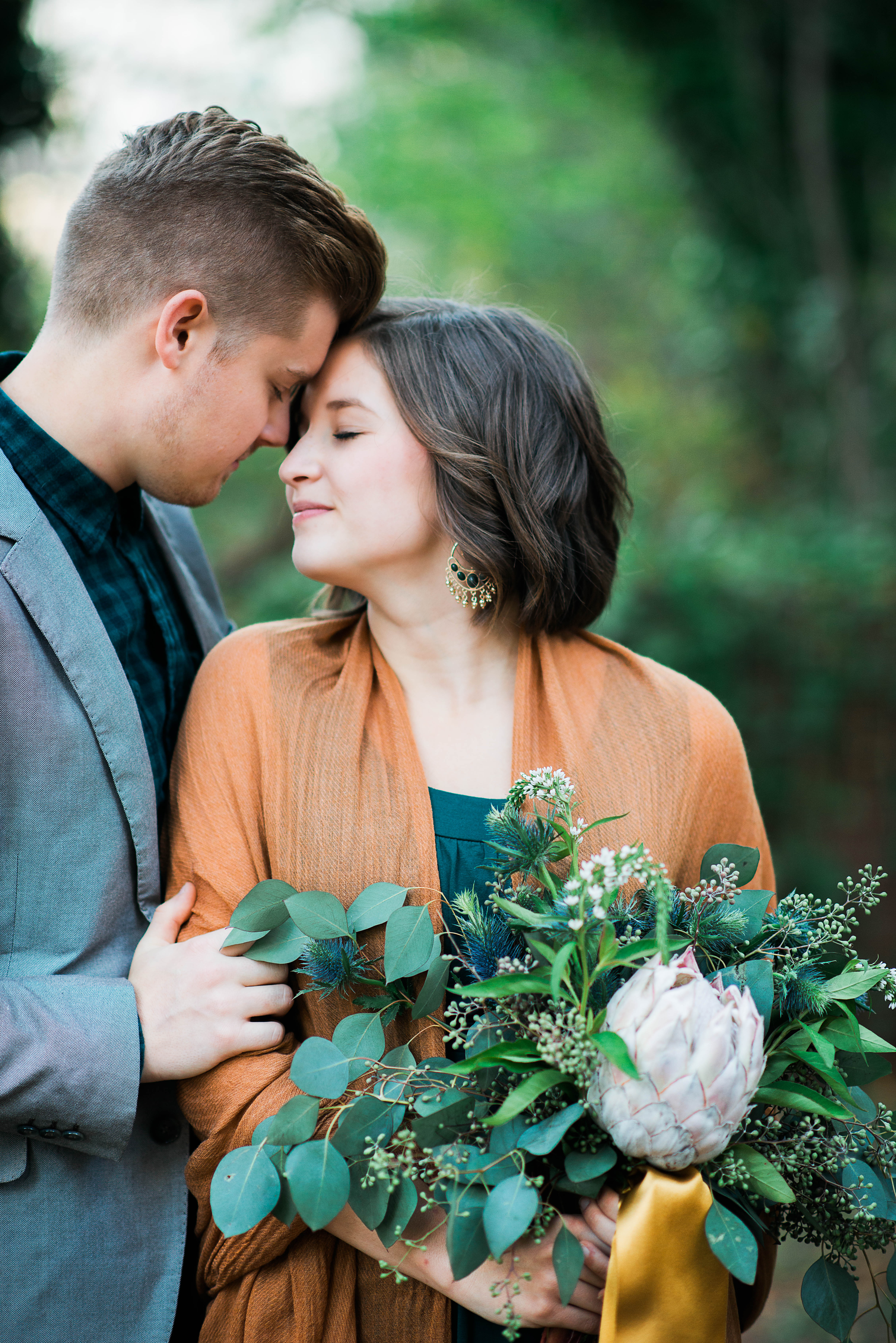 green bouquet and newlyweds