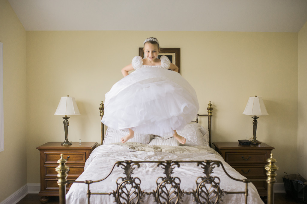 Rockville-Centre-Communion-Photographe-white-dress-jump-bed