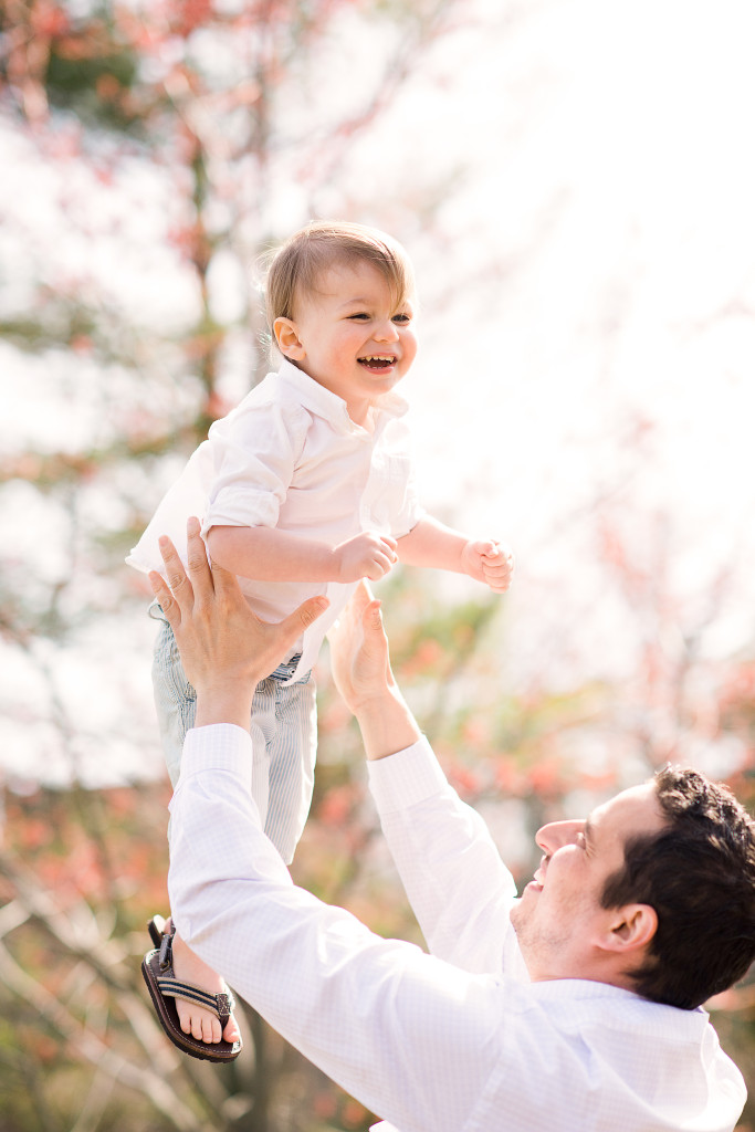 Dad tossing little boy in the air