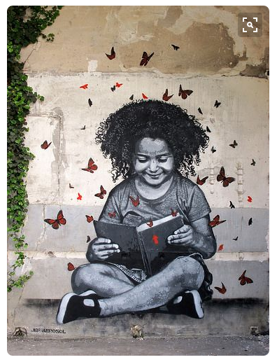 street art painting of girl reading book with butterflies coming out of it