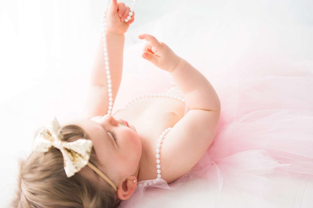 First_Birthday_Photo_Shoot_Long_Island_playing with pearls