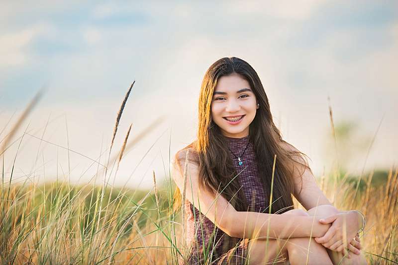 Long Island Portrait Photographer little sister in tall grass