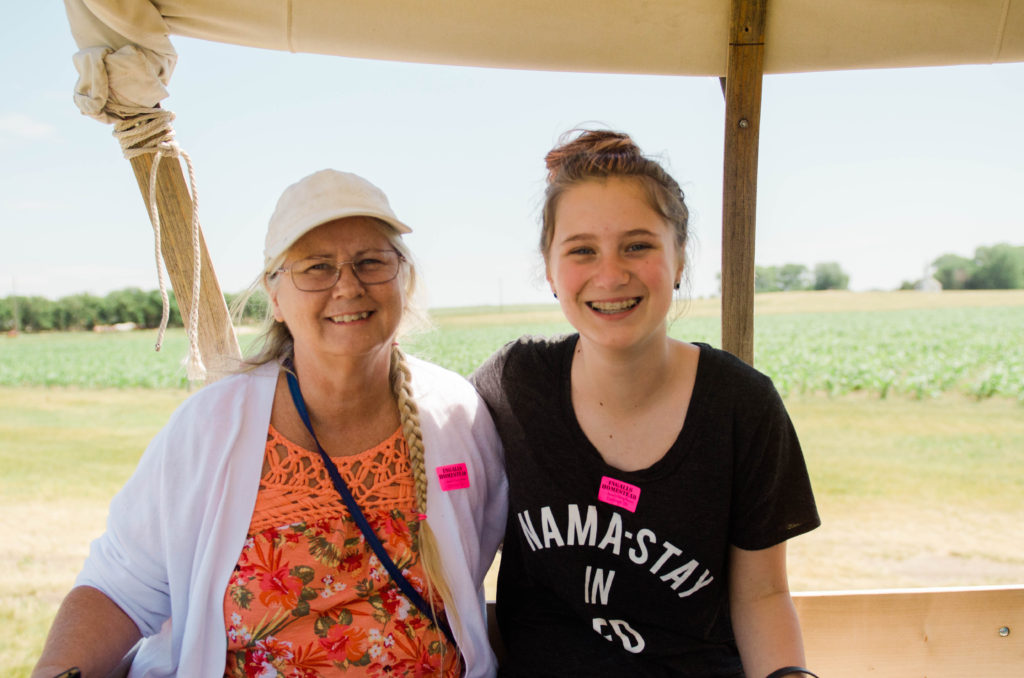 Mom and lana on covered wagon at Ingalls Homestead South Dakota