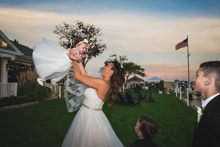 Fun Long Island Wedding Photographer bride mom swings baby girl