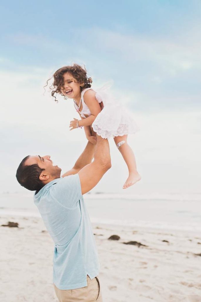 Lynbrook Family Photos dad tosses little girl in the air