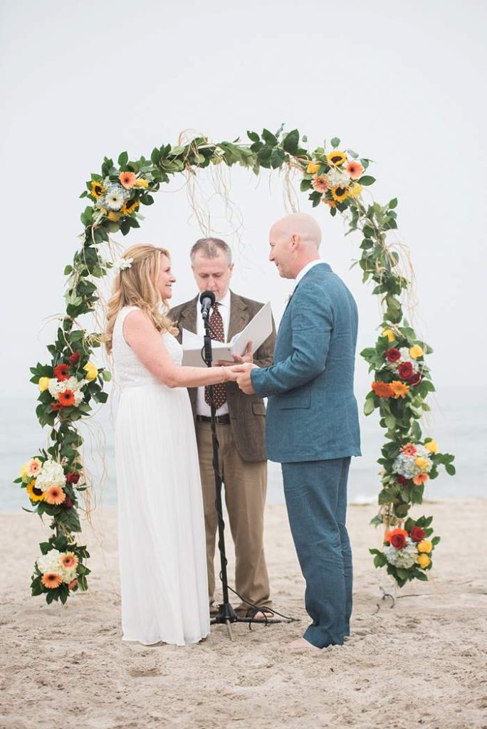 Long Beach NY Beach Wedding ceremony under flower arch