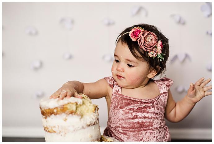 Long Island Boho Cake Smash grabbing cake