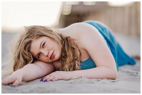 High school Senior Beach Session Long Island on the laying down pose