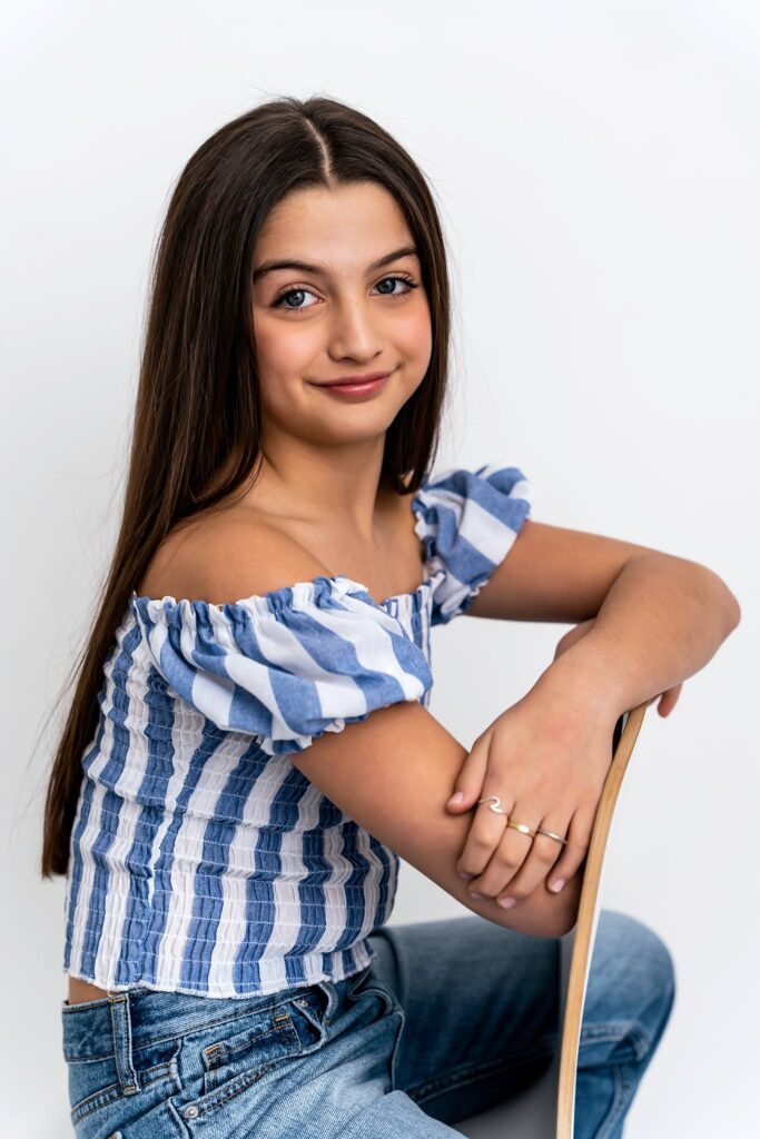 Studio Portraits for Teens Long Island NYC using a chair to poes