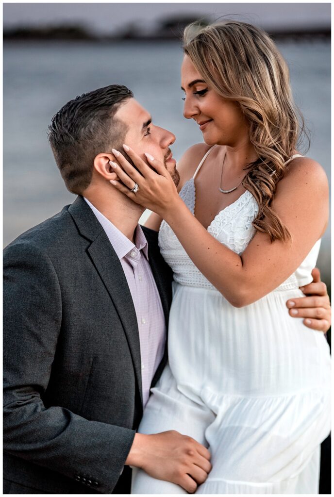 Howard beach couple beach engagement photos holding face