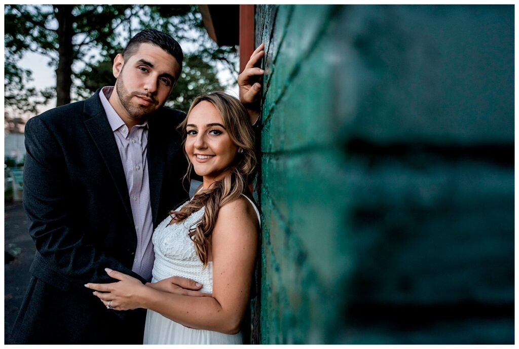 Howard beach couple beach engagement photos leaning on wall