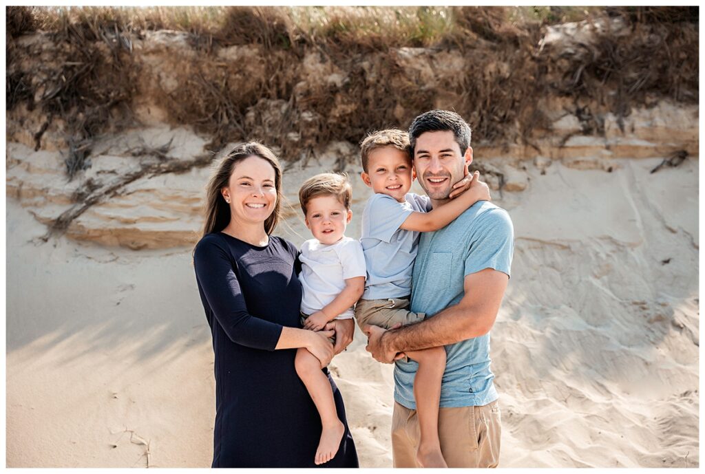 little boys on the beach with mom and dad neck hug