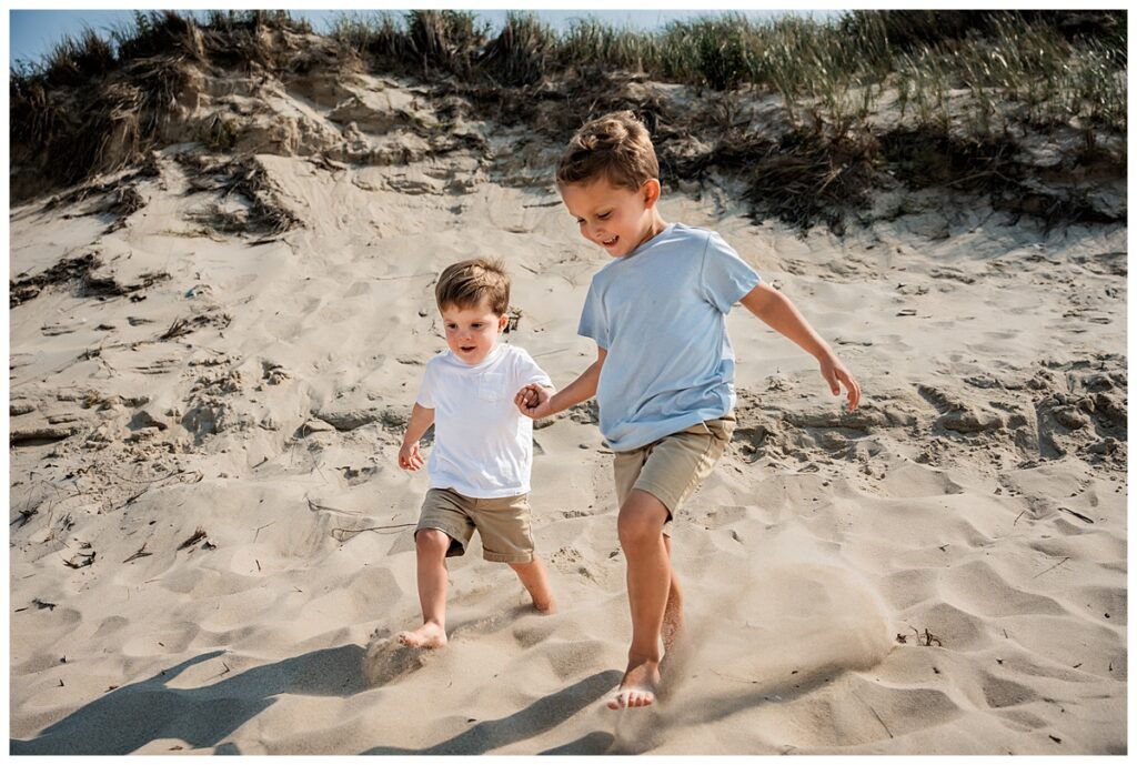 little boys on the beach with mom and dad on the dune