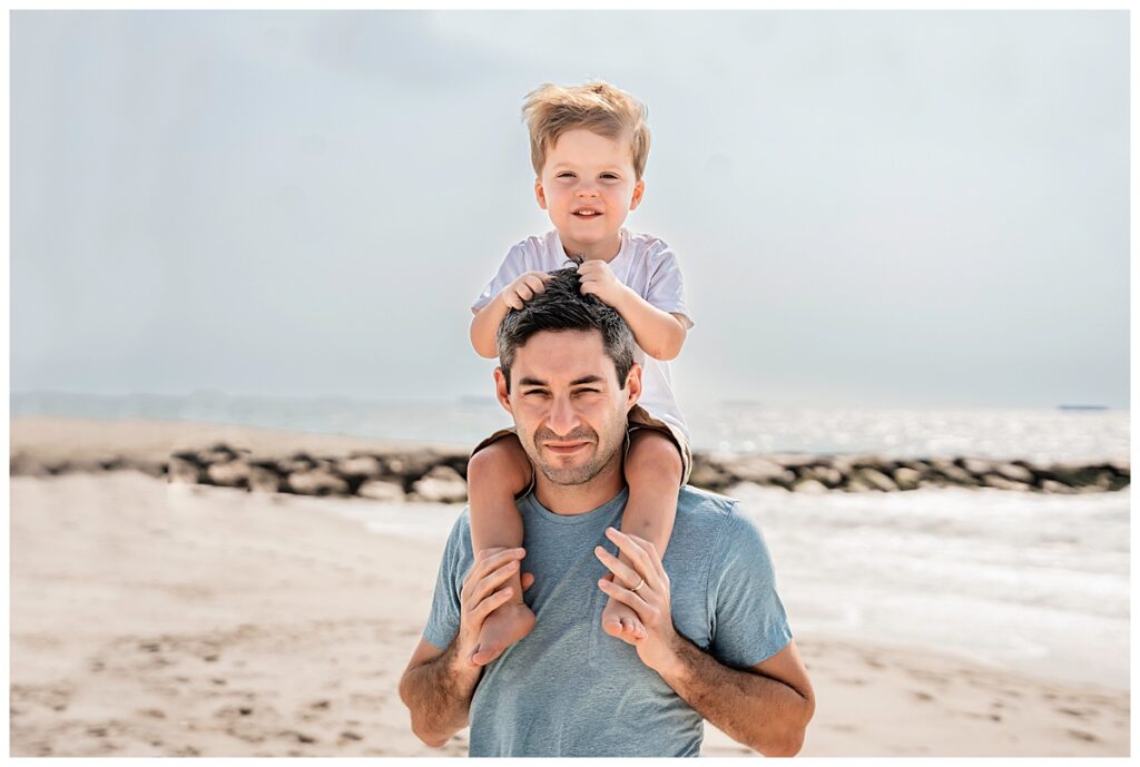 little boys on the beach with mom and dad dad's shoulders