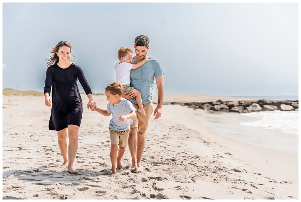 little boys on the beach with mom and dad walking on the beach