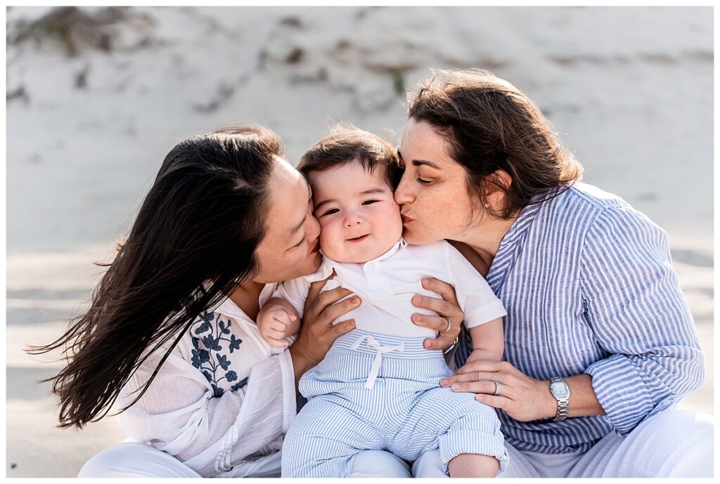 two moms and baby boy family photos on the beach kisses