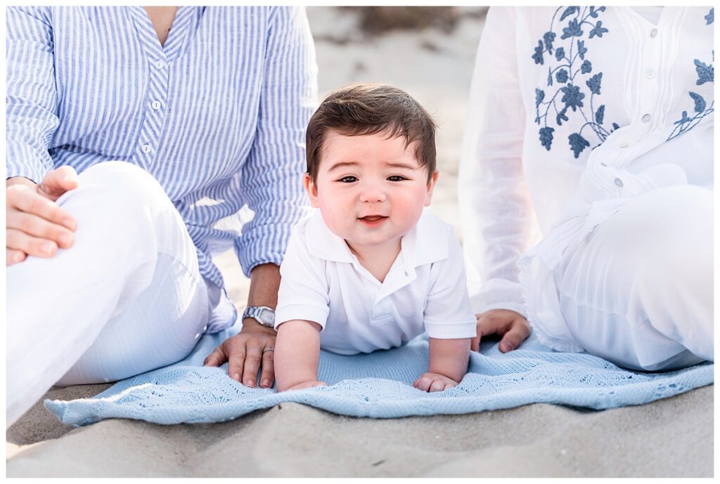 two moms and baby boy family photos on the beach baby pose