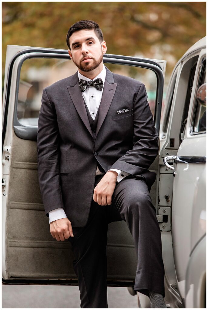 New York City November Wedding groom posing with car