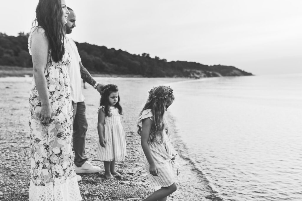 a heart warming family photo in black and white beach