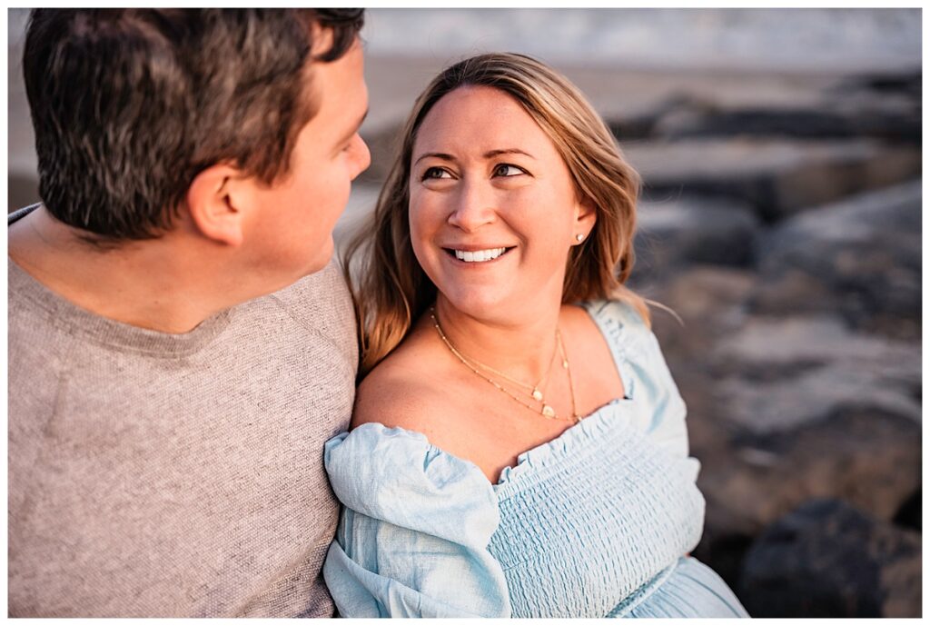 Natural and Breezy Sunset Maternity Photos on the Beach look into each other's eyes