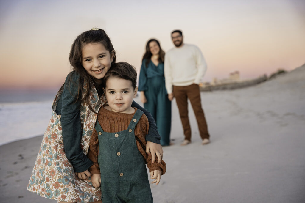 land Family Photographer brother and sister beach