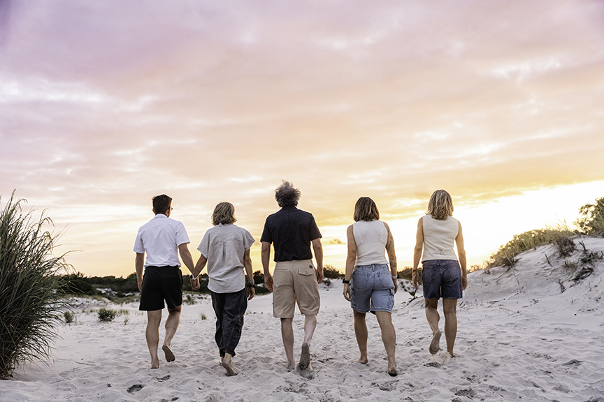 Family-photos-adult-kids-long-beach walking into the sunset