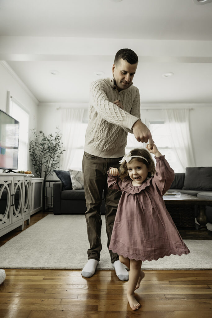 Cozy and Playful In Home New Baby Photos dad and daughter