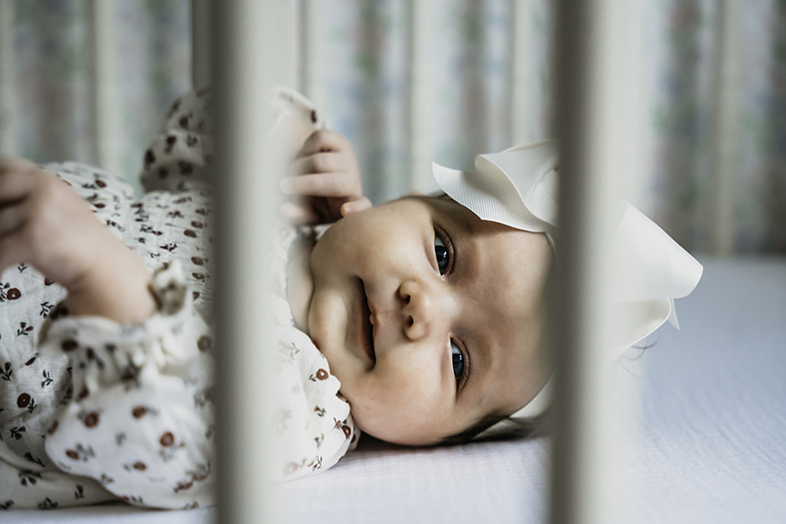 Cozy and Playful In Home New Baby Photos in the crib