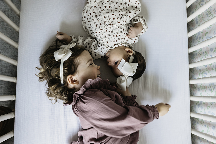 Cozy and Playful In Home New Baby Photos sister look