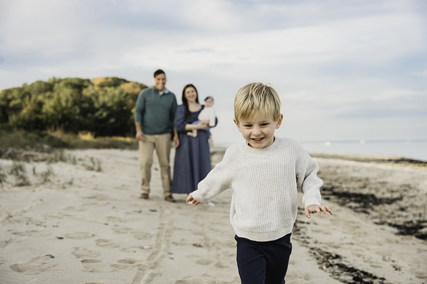 Big brother and baby sister family photos on Long Island active toddler