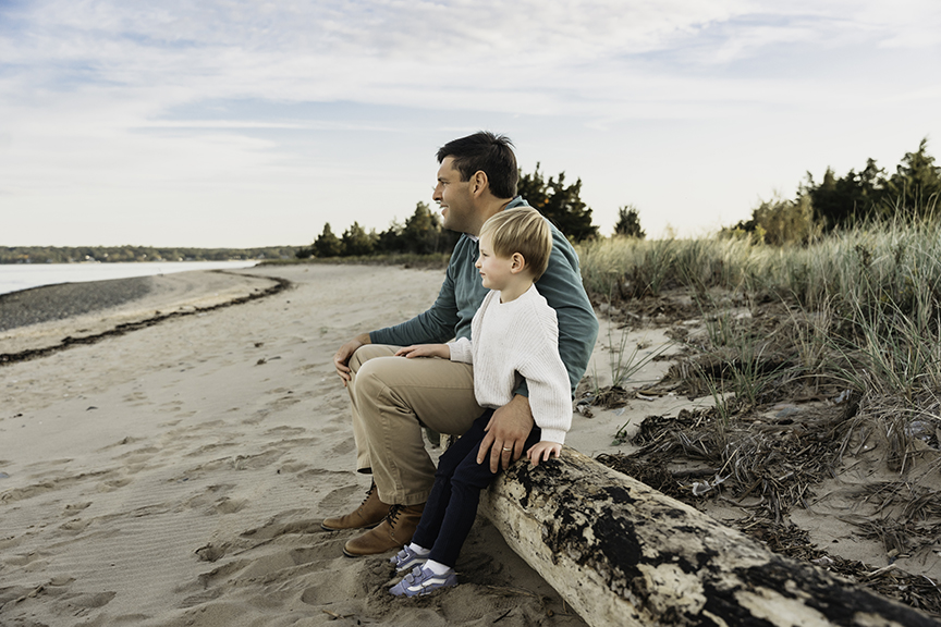 Big brother and baby sister family photos on Long Island tree stump